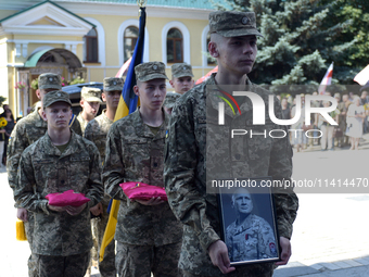 Servicemen are entering St. Michael's Golden-Domed Cathedral after the memorial service of the commander of the OUN volunteer battalion Myko...