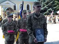 Servicemen are entering St. Michael's Golden-Domed Cathedral after the memorial service of the commander of the OUN volunteer battalion Myko...