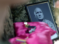 Servicemen are holding the portrait and decorations of the commander of the OUN volunteer battalion Mykola Kokhanivskyi, who died near Vovch...