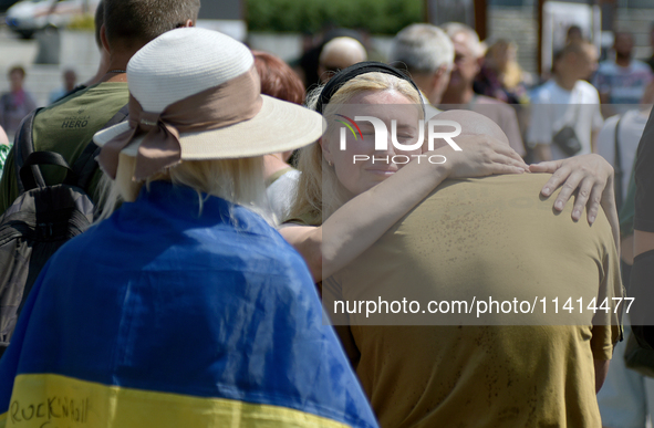 Widow Kateryna is accepting condolences during a memorial event for the commander of the OUN volunteer battalion Mykola Kokhanivskyi, who di...