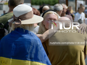 Widow Kateryna is accepting condolences during a memorial event for the commander of the OUN volunteer battalion Mykola Kokhanivskyi, who di...