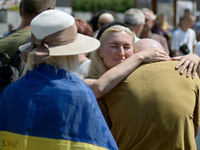 Widow Kateryna is accepting condolences during a memorial event for the commander of the OUN volunteer battalion Mykola Kokhanivskyi, who di...