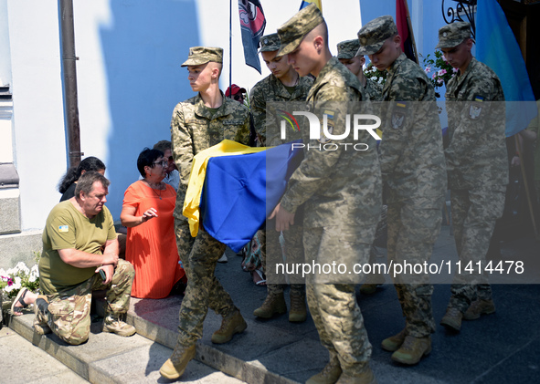 Servicemen are carrying the coffin of the commander of the OUN volunteer battalion Mykola Kokhanivskyi, who died near Vovchansk in Kharkiv r...