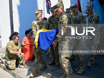 Servicemen are carrying the coffin of the commander of the OUN volunteer battalion Mykola Kokhanivskyi, who died near Vovchansk in Kharkiv r...