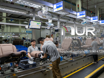 Workers are producing seats ordered by NIO on an assembly line at a workshop of a seating company in Hefei, Anhui province, China, on July 1...