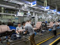 Workers are producing seats ordered by NIO on an assembly line at a workshop of a seating company in Hefei, Anhui province, China, on July 1...