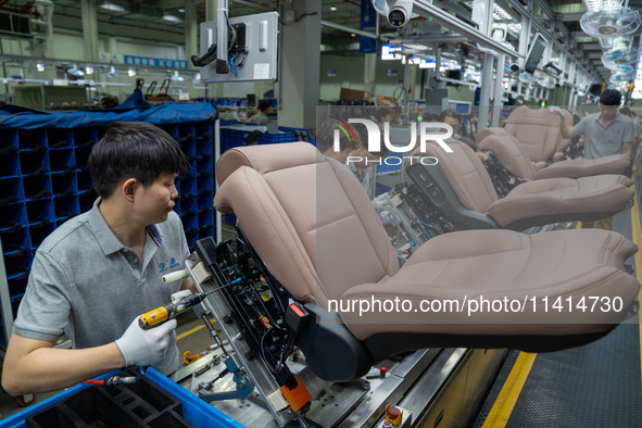 Workers are producing seats ordered by NIO on an assembly line at a workshop of a seating company in Hefei, Anhui province, China, on July 1...