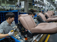 Workers are producing seats ordered by NIO on an assembly line at a workshop of a seating company in Hefei, Anhui province, China, on July 1...