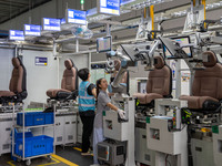 Workers are producing seats ordered by NIO on an assembly line at a workshop of a seating company in Hefei, Anhui province, China, on July 1...