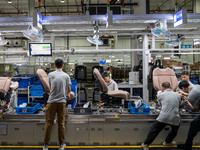 Workers are producing seats ordered by NIO on an assembly line at a workshop of a seating company in Hefei, Anhui province, China, on July 1...