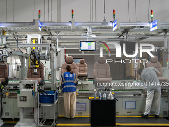 Workers are producing seats ordered by NIO on an assembly line at a workshop of a seating company in Hefei, Anhui province, China, on July 1...