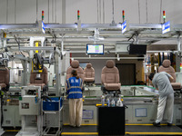 Workers are producing seats ordered by NIO on an assembly line at a workshop of a seating company in Hefei, Anhui province, China, on July 1...