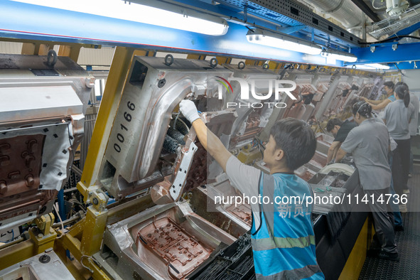 Workers are producing seats ordered by NIO on an assembly line at a workshop of a seating company in Hefei, Anhui province, China, on July 1...