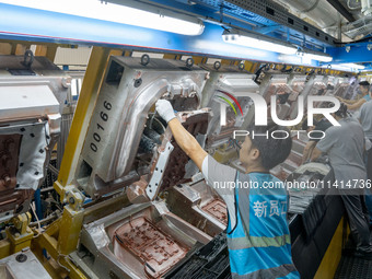 Workers are producing seats ordered by NIO on an assembly line at a workshop of a seating company in Hefei, Anhui province, China, on July 1...