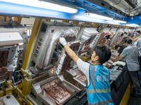 Workers are producing seats ordered by NIO on an assembly line at a workshop of a seating company in Hefei, Anhui province, China, on July 1...