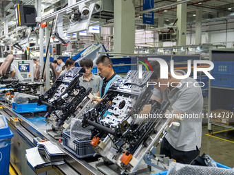 Workers are producing seats ordered by NIO on an assembly line at a workshop of a seating company in Hefei, Anhui province, China, on July 1...