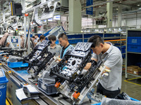 Workers are producing seats ordered by NIO on an assembly line at a workshop of a seating company in Hefei, Anhui province, China, on July 1...