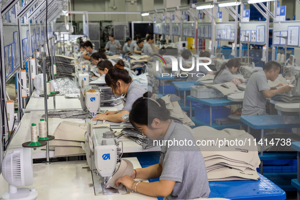 Workers are producing seats ordered by NIO on an assembly line at a workshop of a seating company in Hefei, Anhui province, China, on July 1...