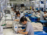 Workers are producing seats ordered by NIO on an assembly line at a workshop of a seating company in Hefei, Anhui province, China, on July 1...