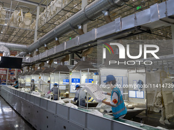 Workers are producing seats ordered by NIO on an assembly line at a workshop of a seating company in Hefei, Anhui province, China, on July 1...