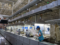 Workers are producing seats ordered by NIO on an assembly line at a workshop of a seating company in Hefei, Anhui province, China, on July 1...