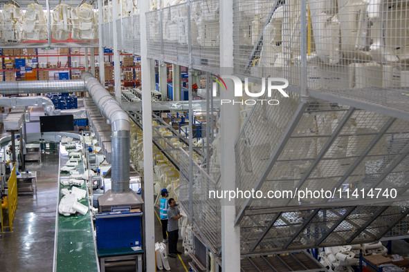 Workers are producing seats ordered by NIO on an assembly line at a workshop of a seating company in Hefei, Anhui province, China, on July 1...