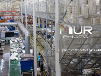 Workers are producing seats ordered by NIO on an assembly line at a workshop of a seating company in Hefei, Anhui province, China, on July 1...