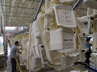 Workers are producing seats ordered by NIO on an assembly line at a workshop of a seating company in Hefei, Anhui province, China, on July 1...