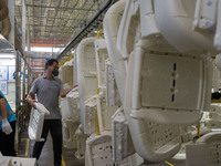 Workers are producing seats ordered by NIO on an assembly line at a workshop of a seating company in Hefei, Anhui province, China, on July 1...