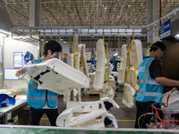 Workers are producing seats ordered by NIO on an assembly line at a workshop of a seating company in Hefei, Anhui province, China, on July 1...