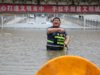 Law enforcement officers of Shizhong District Comprehensive Administrative Law Enforcement Bureau are using a drainage emergency vehicle to...