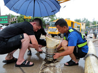 Law enforcement officers of Shizhong District Comprehensive Administrative Law Enforcement Bureau are using a drainage emergency vehicle to...