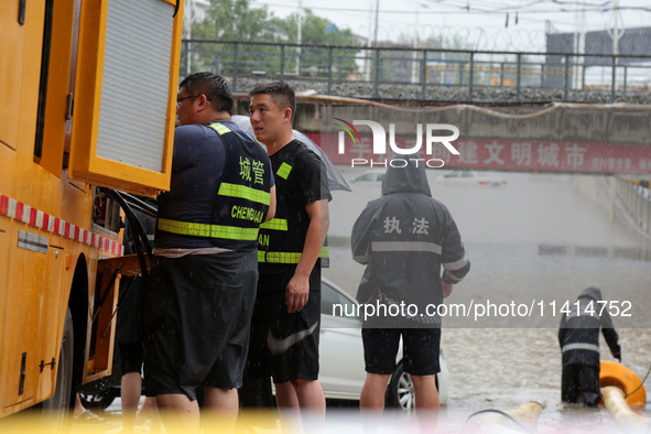 Law enforcement officers of Shizhong District Comprehensive Administrative Law Enforcement Bureau are using a drainage emergency vehicle to...