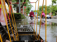 Citizens are wading on Jiefang Road in the Shizhong district of Zaozhuang city, East China's Shandong province, in Zaozhuang, China, on July...