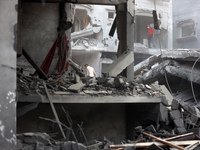 Palestinians are standing on the rubble of Abdullah Azzam Mosque, destroyed in Israeli bombardment in Nuseirat, central Gaza Strip, on July...