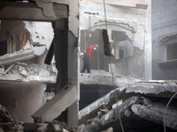 Palestinians are standing on the rubble of Abdullah Azzam Mosque, destroyed in Israeli bombardment in Nuseirat, central Gaza Strip, on July...