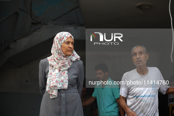 Palestinians are standing on the rubble of Abdullah Azzam Mosque, destroyed in Israeli bombardment in Nuseirat, central Gaza Strip, on July...