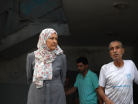 Palestinians are standing on the rubble of Abdullah Azzam Mosque, destroyed in Israeli bombardment in Nuseirat, central Gaza Strip, on July...