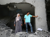 Palestinians are standing on the rubble of Abdullah Azzam Mosque, destroyed in Israeli bombardment in Nuseirat, central Gaza Strip, on July...