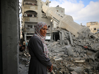 Palestinians are standing on the rubble of Abdullah Azzam Mosque, destroyed in Israeli bombardment in Nuseirat, central Gaza Strip, on July...