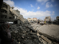 Palestinians are standing on the rubble of Abdullah Azzam Mosque, destroyed in Israeli bombardment in Nuseirat, central Gaza Strip, on July...