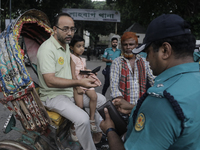 Police officers are checking IDs of civilians as the entrance of Dhaka University area is restricted due to violence in Dhaka, Bangladesh, o...