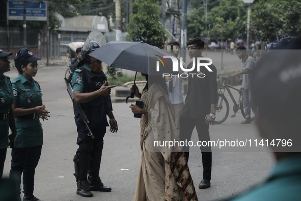 Police officers are checking IDs of civilians as the entrance of Dhaka University area is restricted due to violence in Dhaka, Bangladesh, o...