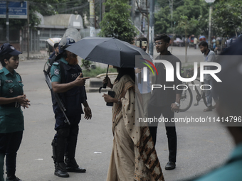 Police officers are checking IDs of civilians as the entrance of Dhaka University area is restricted due to violence in Dhaka, Bangladesh, o...