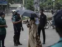 Police officers are checking IDs of civilians as the entrance of Dhaka University area is restricted due to violence in Dhaka, Bangladesh, o...