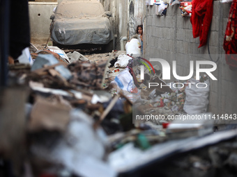 Palestinians are inspecting a house destroyed in an Israeli strike, amid the Israel-Hamas conflict, in Nusairat refugee camp, in the central...