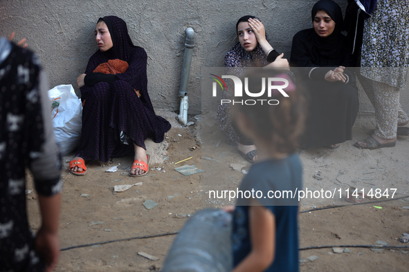 Palestinian women are reacting at the site of an Israeli strike on a house, in Nuseirat, central Gaza Strip, on July 17, 2024, amid the ongo...