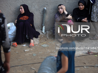 Palestinian women are reacting at the site of an Israeli strike on a house, in Nuseirat, central Gaza Strip, on July 17, 2024, amid the ongo...