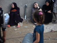 Palestinian women are reacting at the site of an Israeli strike on a house, in Nuseirat, central Gaza Strip, on July 17, 2024, amid the ongo...