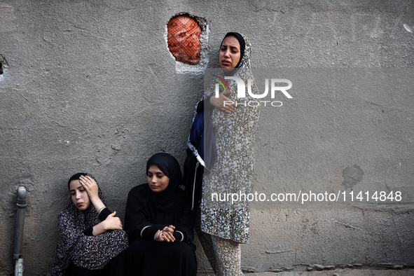 Palestinian women are reacting at the site of an Israeli strike on a house, in Nuseirat, central Gaza Strip, on July 17, 2024, amid the ongo...